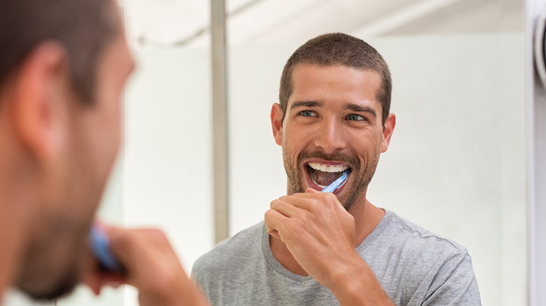 A man brushes his teeth