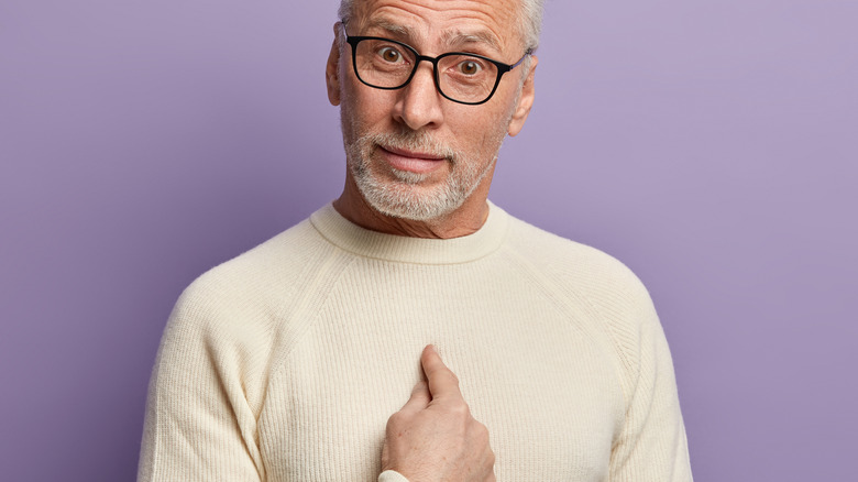 Man pointing to himself