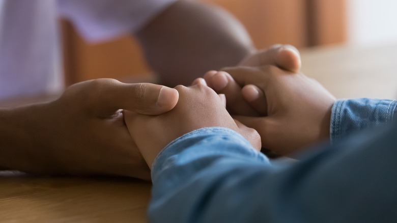 Close-up of couple holding hands