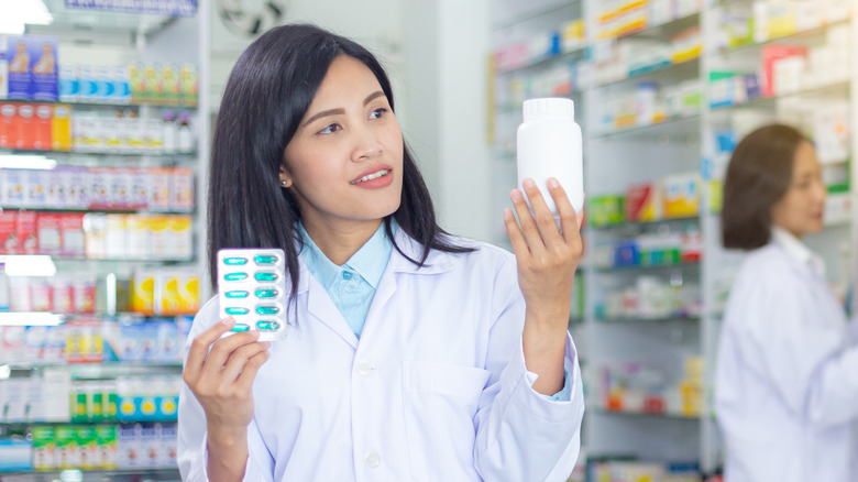 Pharmacist looking at bottle