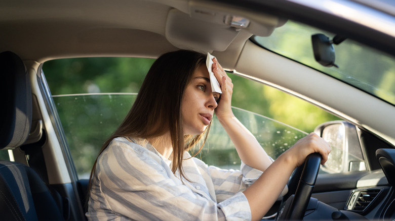 female driver sweating in her car