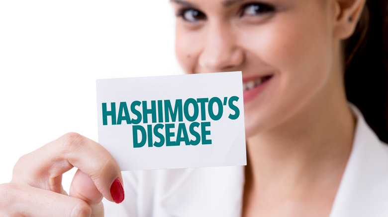 Woman holding up Hashimoto's disease sign