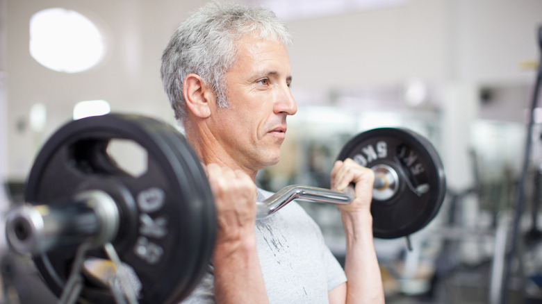 older man doing dumbbell curls