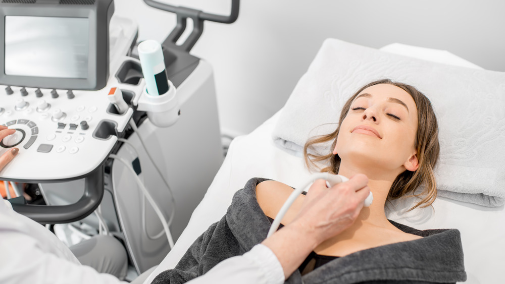 Woman getting ultrasound of thyroid