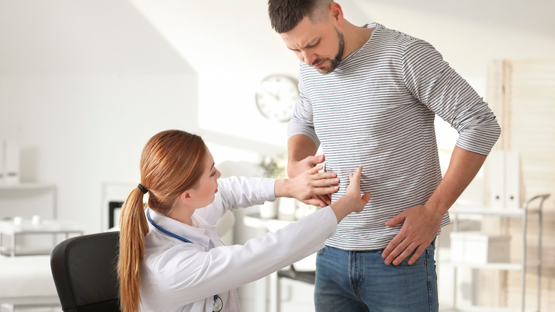 Gastroenterologist examining a male patient with IBS