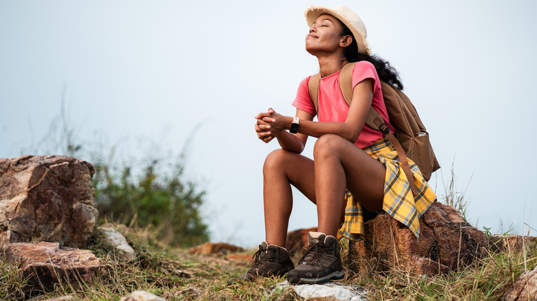 Happy woman relaxing during a hike