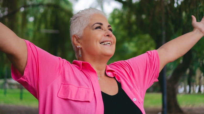 Healthy senior woman stretching her arms