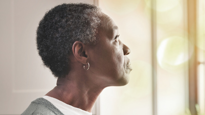 Senior woman staring out the window