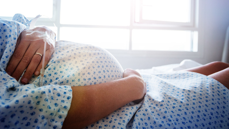 Pregnant person in hospital bed