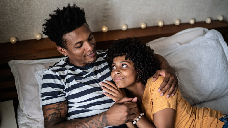 Loving couple laying in bed