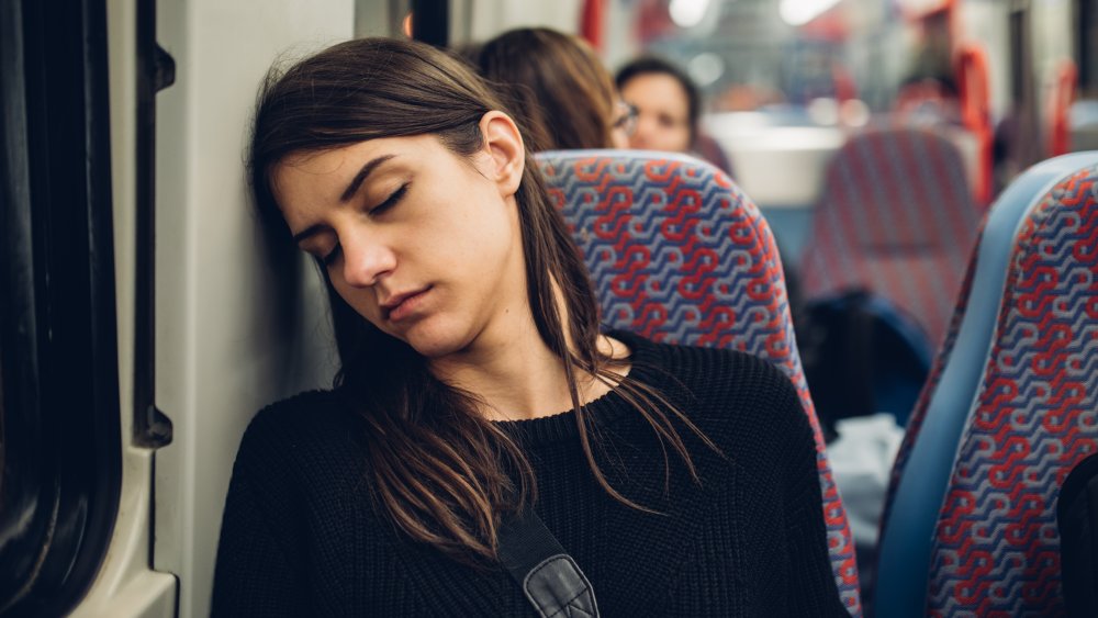 Woman falling asleep on public transportation