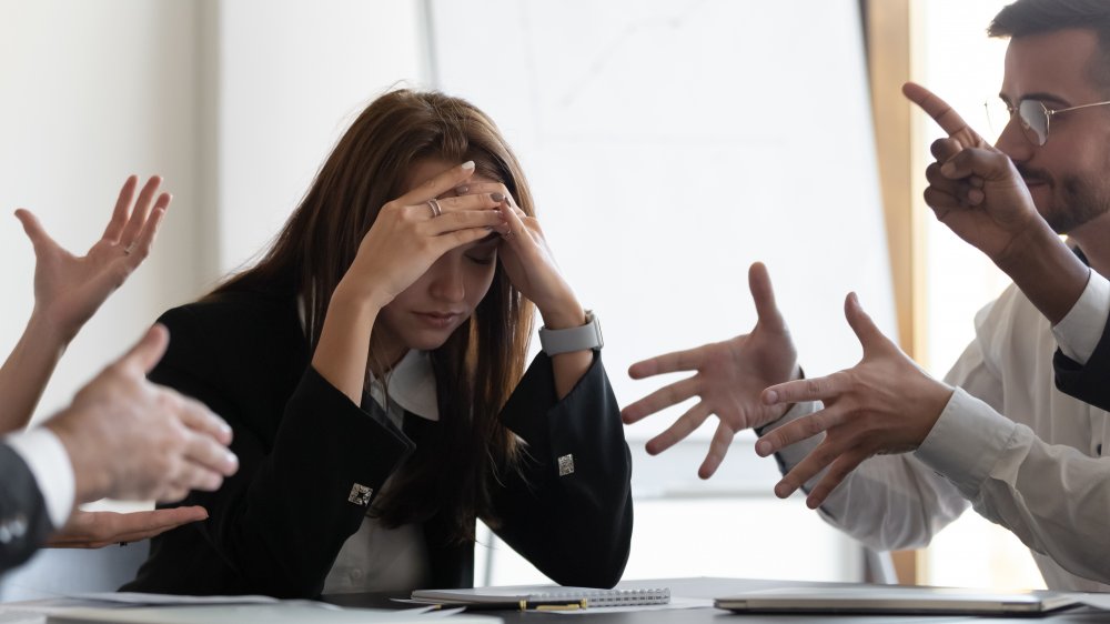 Confused woman in office meeting