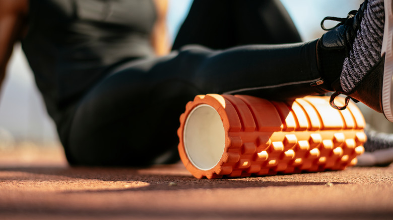 athlete using a foam roller on a rest day