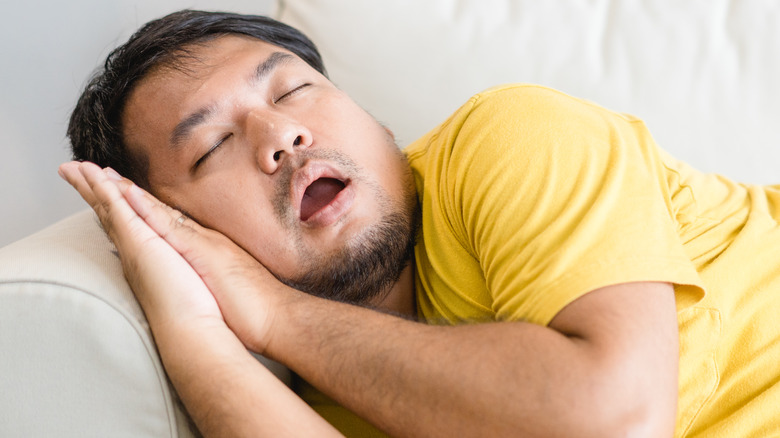 a man asleep on the couch 