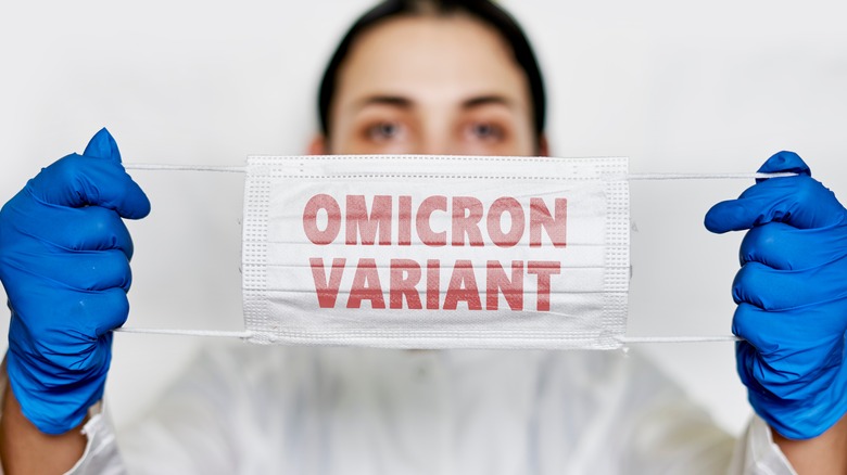 woman holding face mask with words