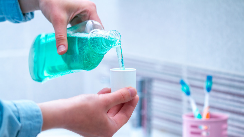 Person pouring out mouthwash