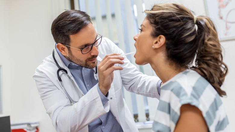 Woman at the doctor having mouth inspected