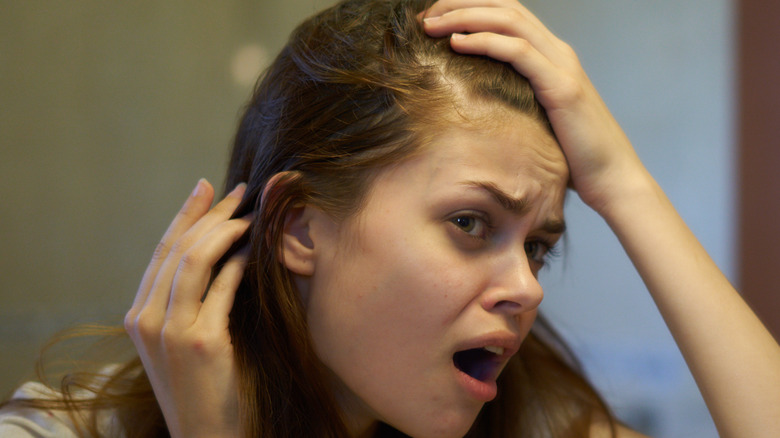 Girl examining hairline