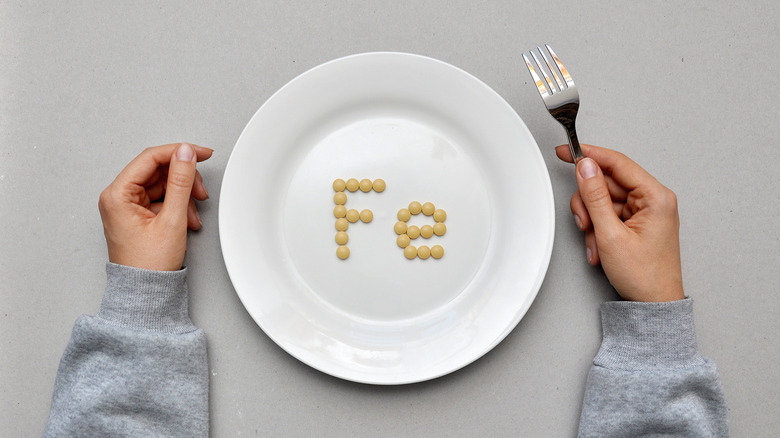 Sign of the trace element "iron" created from tablets on a white plate