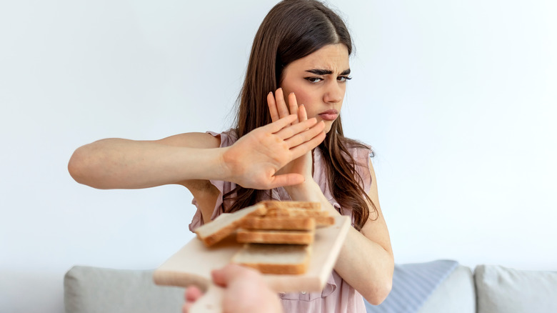 woman rejecting bread