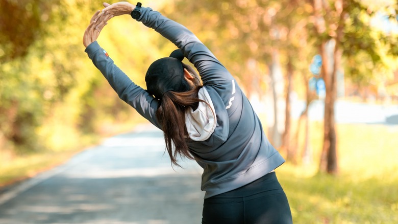 woman outdoors stretching before run