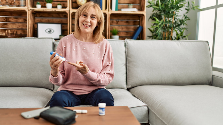 Diabetic woman using glucometer