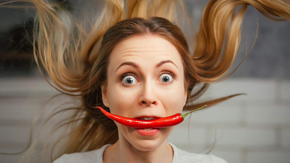 woman eating hot pepper