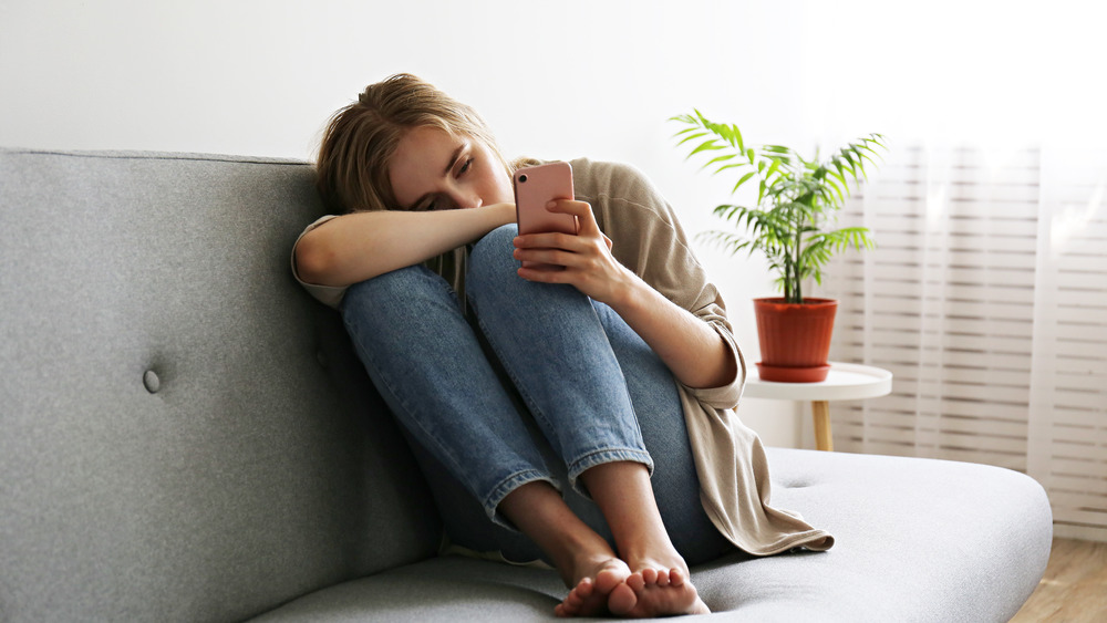 depressed woman on couch