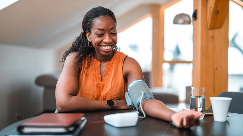 woman measuring high blood pressure at home