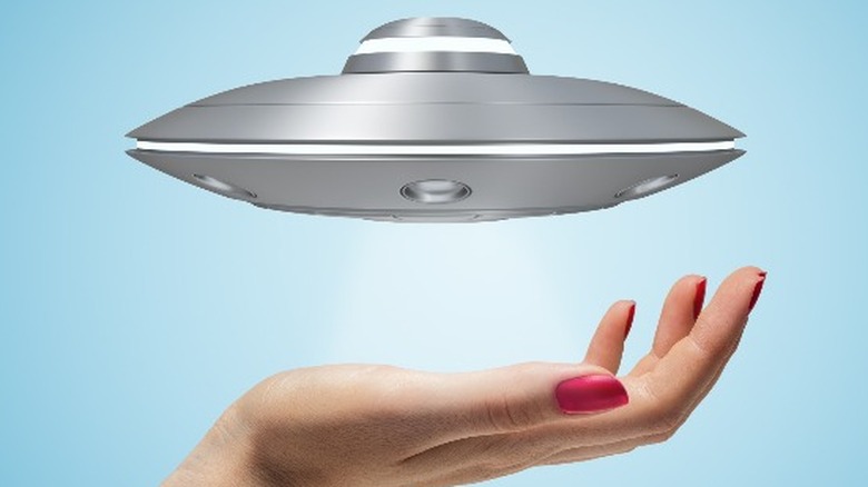 woman holds alien ship in hand 