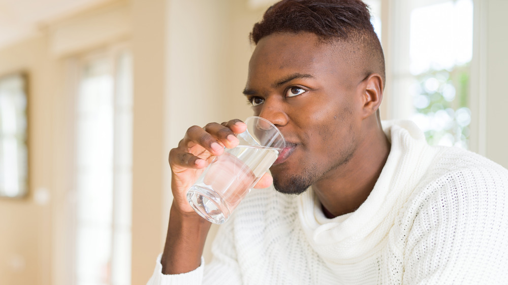 young man drinking water