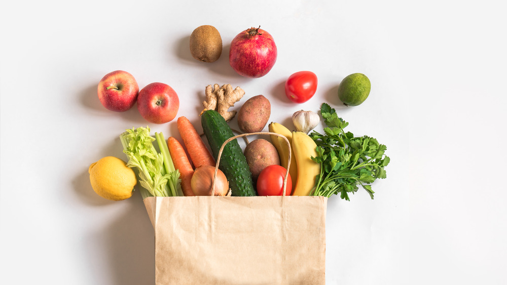 A grocery bag filled with fruits and vegetables
