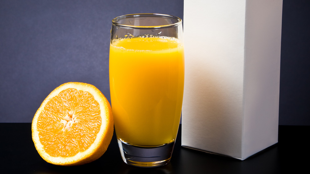 Orange juice and orange slices on a white background