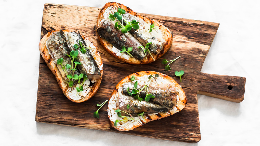 Sardines on toast on a cutting board