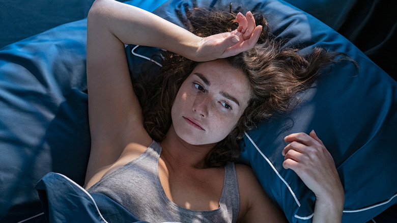 insomniac woman laying in bed