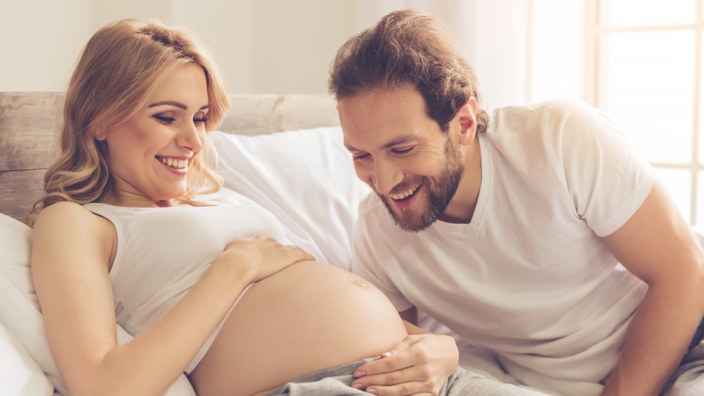 pregnant woman in bed with man