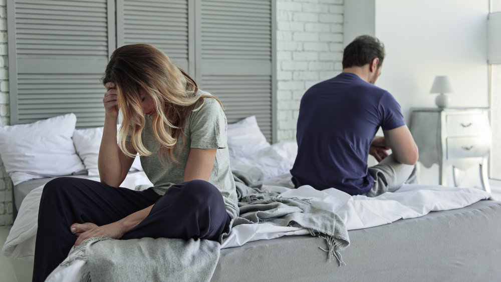 stressed couple in bed