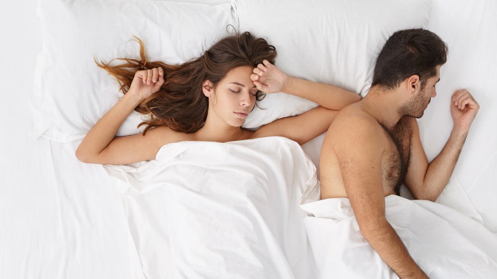 exhausted couple in bed