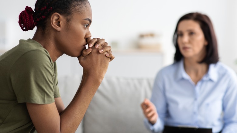  young female soldier speaking to therapist 