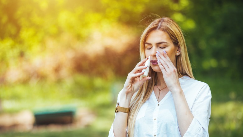 woman using nasal spray