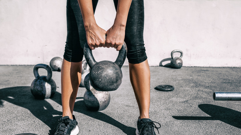 Woman holding kettlebell in outdoor gym