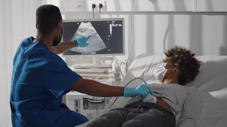 Woman getting ultrasound with doctor