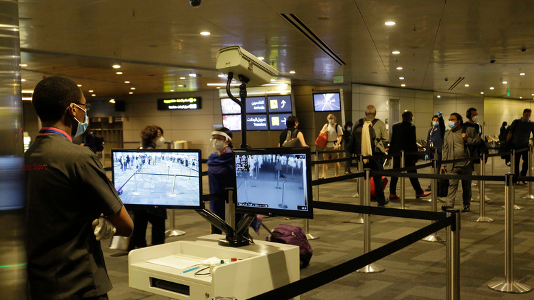 travelers wearing masks in airport