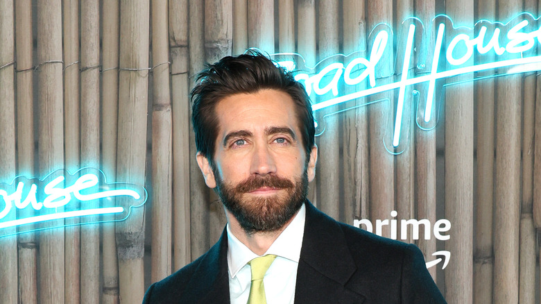 Jake Gyllenhaal in front of "Road House" sign