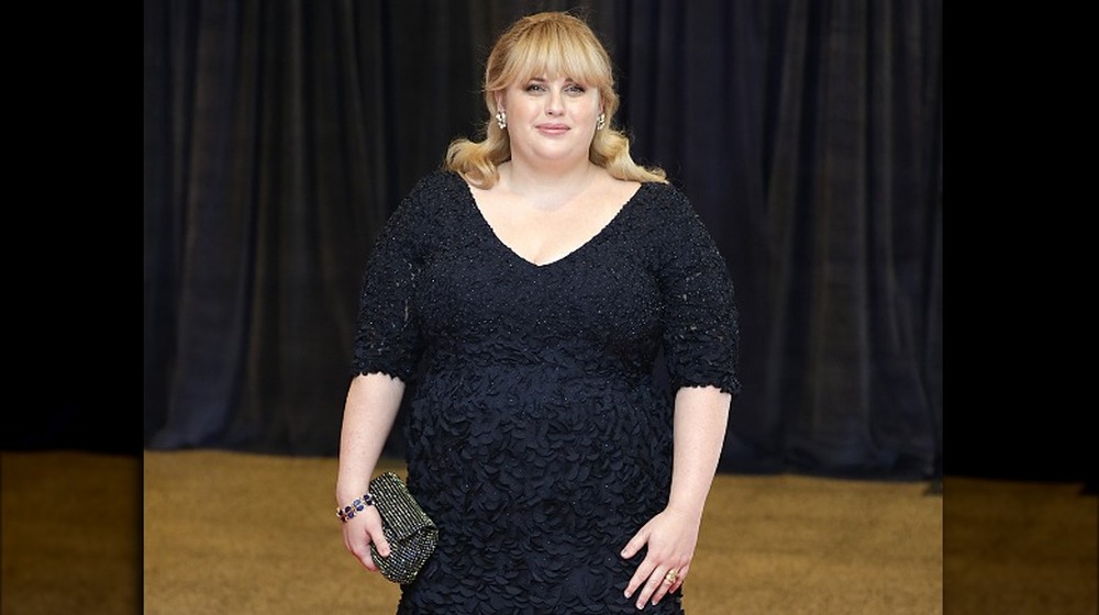 Rebel Wilson standing on the red carpet