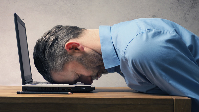 man asleep at desk