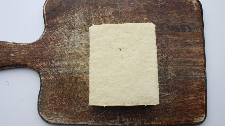 tofu block on cutting board