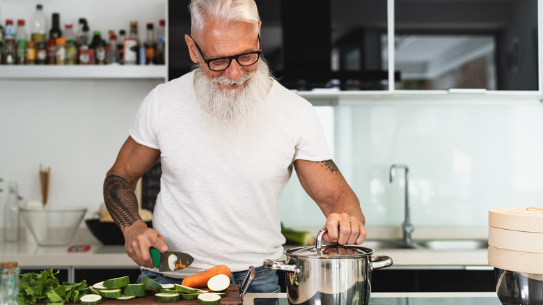 Senior man cooking vegetables