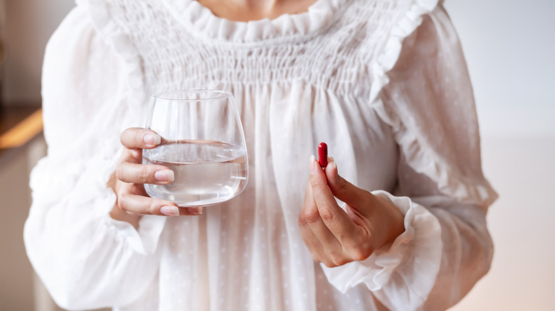 woman taking iron tablets