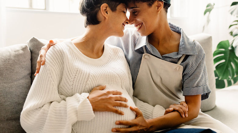 pregnant couple smiling 